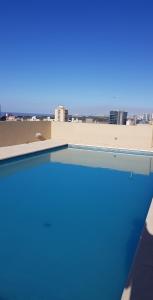 a swimming pool with a view of the city at Fantástico depto. con vistas panorámicas in Vicente López
