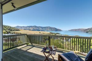 a deck with a view of the water at Seaview Outlook - Wainui Holiday Home in Wainui