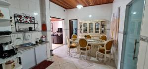 a kitchen with a table and chairs in a room at Casa Ouro Preto in Ouro Preto