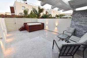 a patio with chairs and a tub on a building at סוויטת נסיכת המפרץ in Eilat