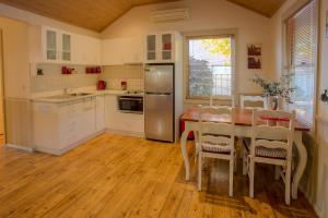 a kitchen with a table and a stainless steel refrigerator at Autumn Affair Cottage 6 in Bright