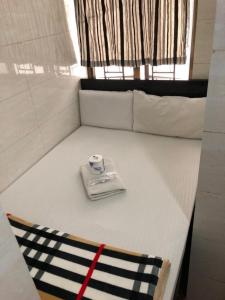 Una cama con una servilleta y una taza. en Crystal Hostel, en Hong Kong