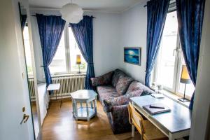 a living room with a couch and a table at Park Hotell in Örnsköldsvik