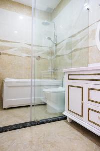 a bathroom with a shower and a tub and a sink at Quoc Vinh Hotel in Rạch Giá