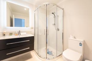 a bathroom with a shower and a toilet and a sink at Star View in Lake Tekapo +17 photos