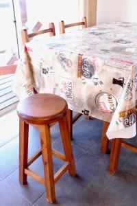 uma mesa e duas cadeiras com uma mesa e uma toalha de mesa em Koe Porá em Punta Del Diablo