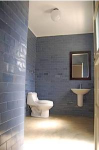 a bathroom with a toilet and a sink at Casa Colonial in Mindelo