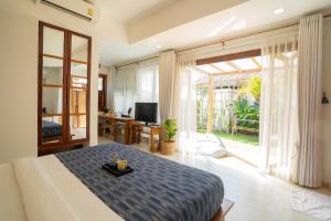 a bedroom with a bed and a large window at Rest Sea Resort Koh Kood in Ko Kood