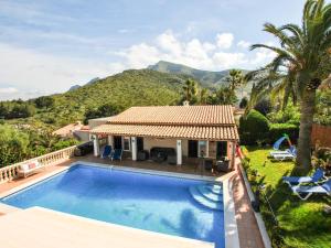 a villa with a swimming pool and a house at Belvilla by OYO Casa Aim Eri in Alcudia