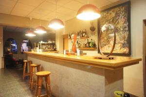 a bar in a restaurant with bar stools at Hotel MR in Tarragona