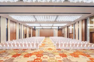 an empty hall with white chairs and wooden walls at Novotel Changsha International Exhibition Center in Changsha