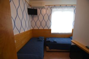 מיטה או מיטות בחדר ב-Hotel la Conchiglia