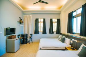 Postelja oz. postelje v sobi nastanitve Fun Trip - Fu May Sea View Holiday house l 無敵海景交誼廳 l 附汽機車租賃 l