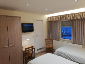 Postel nebo postele na pokoji v ubytování Arconaty Hotel