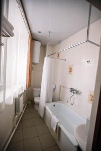 a bathroom with a tub and a toilet and a sink at Praga Hotel in Ulan-Ude