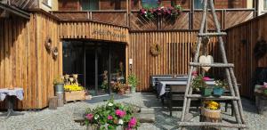 a building with flowers and plants in front of it at Hotel Primula in Livigno
