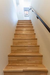 a stairwell with wooden steps with a picture on the wall at VACATION INN KAMATA I in Tokyo