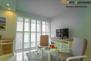 A television and/or entertainment center at Baltic-Apartments - Flotylla 14 Bay View