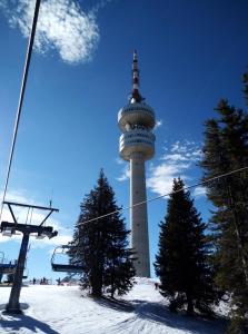 a tower on top of a ski slope with a ski lift at Elza Apartment in Pamporovo
