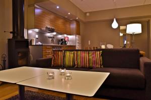 a living room filled with furniture and a coffee table at Levi Suites Unna Mànnu in Levi