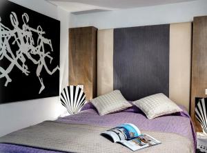 a bedroom with a bed with a book on it at Villa Marina Little Beach in Capri