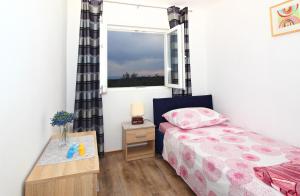 a bedroom with a bed and a window at Apartment Milenka in Čilipi