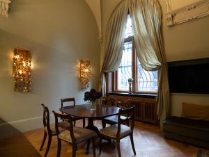 a dining room with a table and chairs and a window at ARVED Apartments in Lübeck