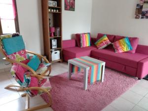 a living room with a couch and a table at L'Auberge in Abjat