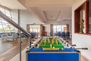 a conference room with a pool table and chairs at StayVista's White Pebbles - A Villa with Theater Room & Swimming Pool in Lonavala