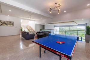 a living room with a ping pong table in it at StayVista's White Pebbles - A Villa with Theater Room & Swimming Pool in Lonavala