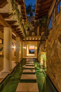 a swimming pool in a house with a stone wall at 1037 - Villa Escondida in Santa Cruz Huatulco