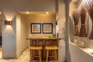 a bar in a room with two stools at 1037 - Villa Escondida in Santa Cruz Huatulco
