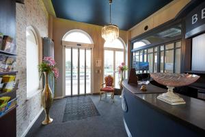 a large room with a desk and some windows at Hotel Belvedere in Warnemünde