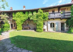 an exterior view of a house with a yard at Cascina del Tempo Sospeso in Bogogno