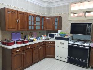 A kitchen or kitchenette at Elite Homes 3BR Garden Apartment Families Only