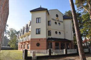 a building with a sign on the front of it at Villa Solaris in Niechorze