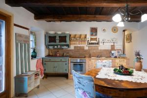 a kitchen with a table and a counter top at Magdolna Vendégház Magánszálláshely in Écs