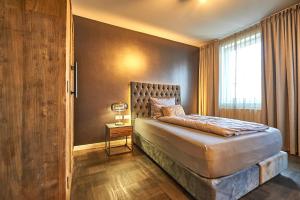 a bedroom with a large bed and a window at Hotel Belvedere in Warnemünde