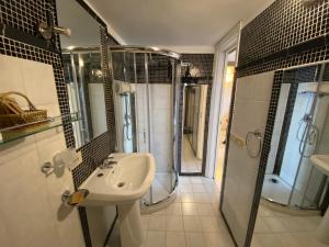 a bathroom with a sink and a shower at Villa Don Mimì Guarnaschelli la dependace in Taormina +33 photos