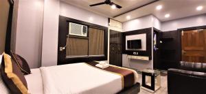 a bedroom with a bed and a television in it at DORA HOUSE in Kolkata