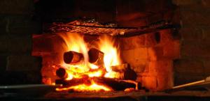 a brick oven with a fire in it at Villa Santarsa con piscina privata in Sansepolcro