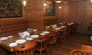 a row of tables and chairs in a restaurant at Metro Plaza Hotel by RAK Rooms, Mangaluru in Mangalore