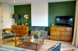 a living room with a couch and a tv at Tarn End Cottage 8, Talkin Tarn, Brampton in Carlisle