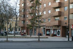 a large brick building on a city street at Hostal Puente de Piedra in Zaragoza