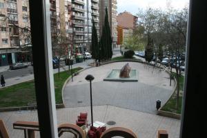 a view of a fountain from a window at Hostal Puente de Piedra in Zaragoza