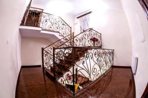 a spiral staircase in a white room with a stair case at Hotel "XAVIER" in Lubycza Królewska