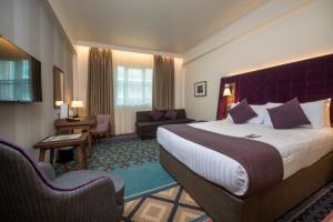 a hotel room with two beds and a large window at Mercure London Bridge in London