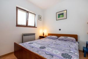 Postel nebo postele na pokoji v ubytování Apartments Biserka in Banjole