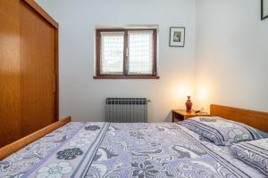 Postel nebo postele na pokoji v ubytování Apartments Biserka in Banjole
