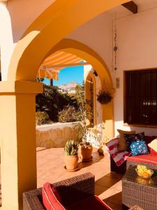 un patio con un arco con sofá y sillas en Cassandra - Beautiful Private Villa with Heated Pool included, en Jávea